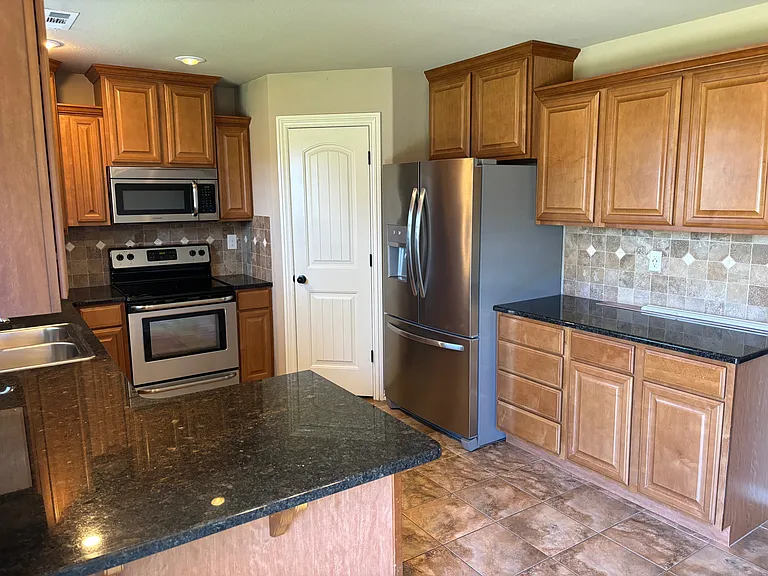 Kitchen with eat in bar and all stainless appliances