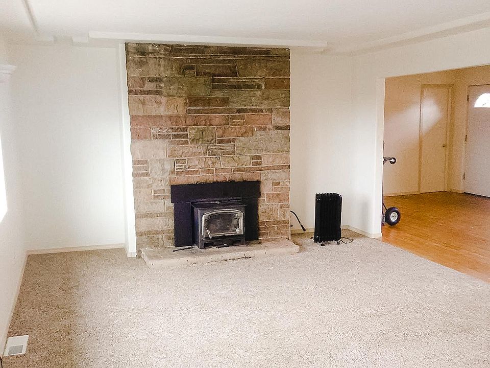 Living room with wood burning fireplace.