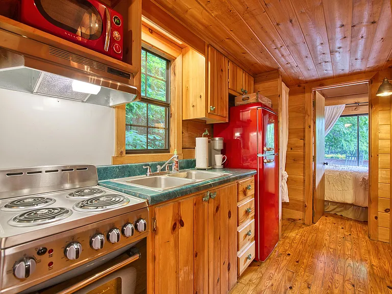 Kitchen with fridge/ freezer, range and microwave