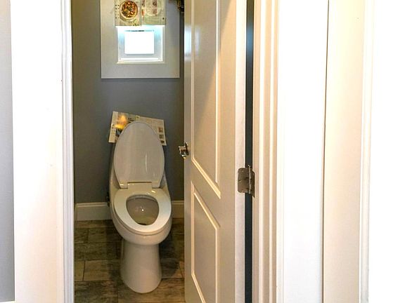 Split bathroom with toilet, ventilation fan.