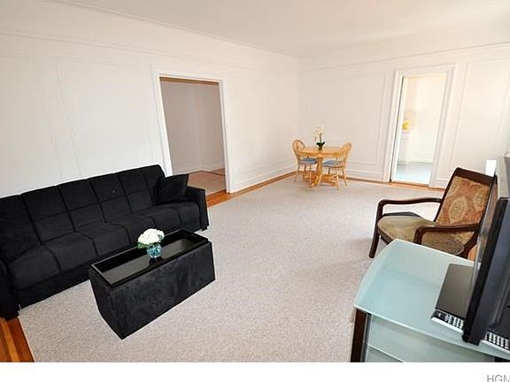 Large Living room has hardwood floors and in-laid trim.  The room has picture moldings, wall moldings and a cove ceiling.  There is a ten panel glass butler door to the eat-in-kitchen.  The room is 21'-0" x 13'-0".