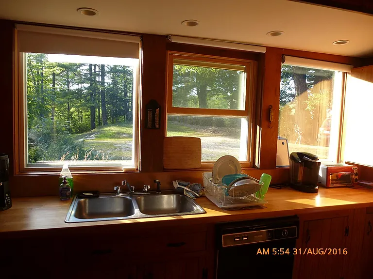 The kitchen looks out to the driveway entrance.