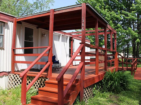 Nice covered deck at the entrance with handicapped accessible ramp.