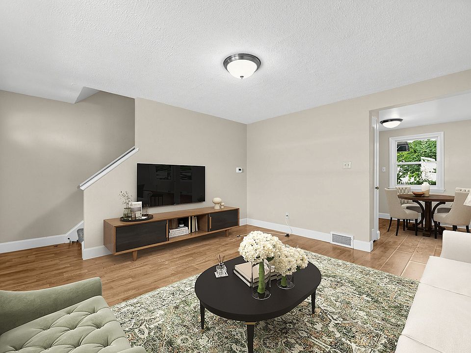 Step into the inviting living area of Crestwood Townhomes, where modern aesthetics meet comfort. The spacious layout and stylish decor create the perfect setting for relaxation and entertaining. Explore your new home today!