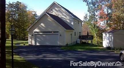 House from driveway - Shed off to right
						:
						Large oversized driveway offers plenty of parking areas. Garage is finished