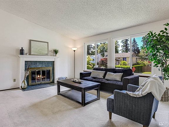 On the upper level, the living room offers an abundance of natural light and vaulted ceilings creating a spacious feel.