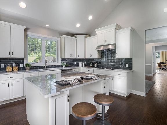 Kitchen with center island open to the living room