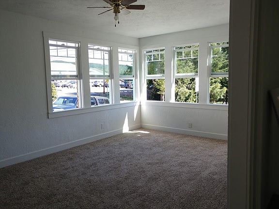 airy light living room with ceiling fan