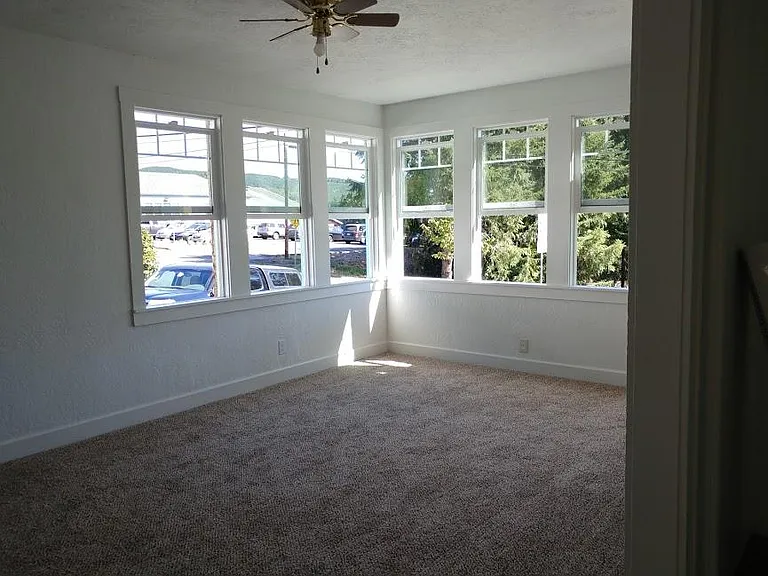 airy light living room with ceiling fan