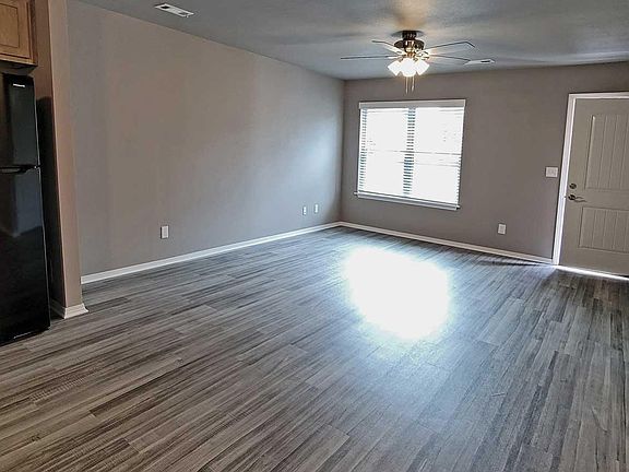 Well-lit living room with ceiling fan