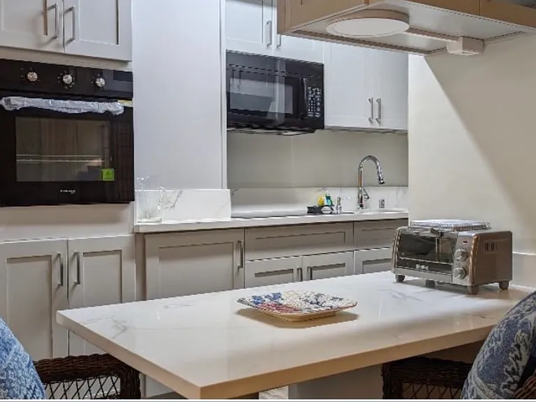 Kitchen: Wall oven, Microwave, glass touch top stove(under microwave) & full size Refrigerator/Freezer across from sink. Lots of cabinet storage filled with Dishes, cups, bowls, utensils, pots, pans, bake wear, etc! Bright lighting above kitchen table.