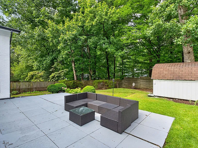 Patio overlooking yard and massive storage shed