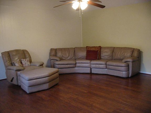 Spacious living area is accented with beautiful wood laminate floors.