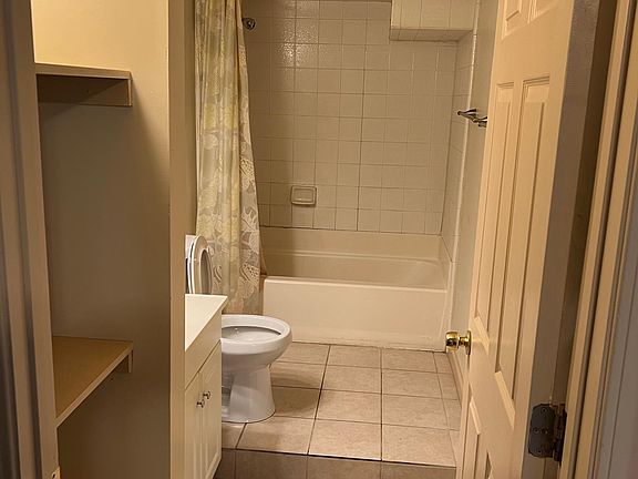 Recently updated large bath with linen shelves.
