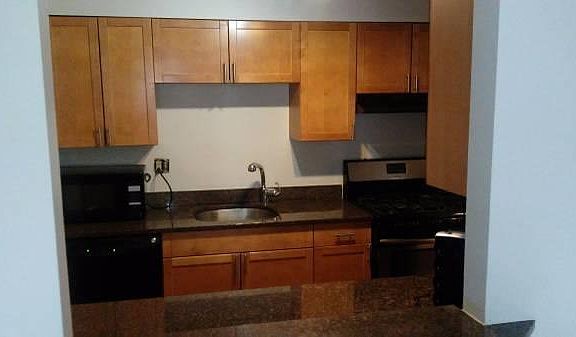 Kitchen stocked with appliances, dinnerware, and cutlery
