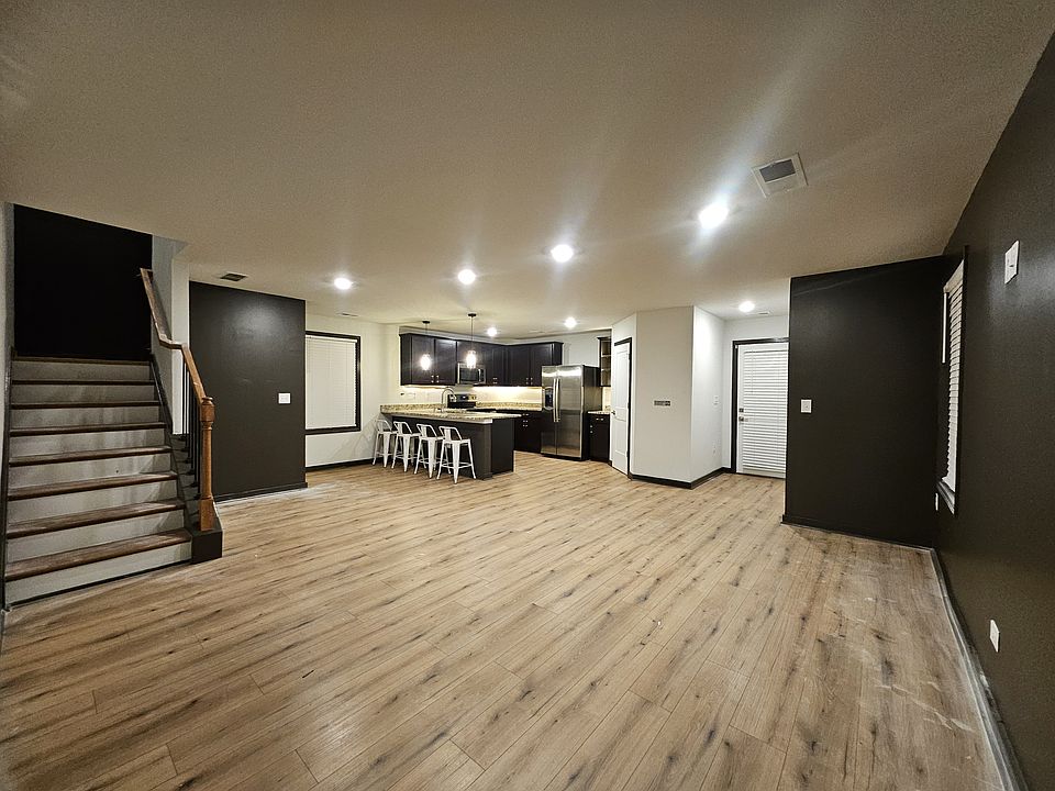 Open-concept main level with sleek black accents, wood-look flooring, and recessed lighting_modern design meets everyday functionality.