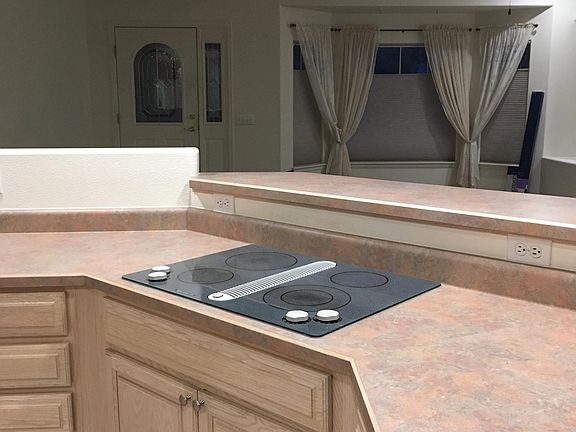 Kitchen overlooks living room and front door.