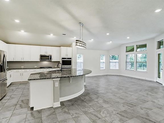 The spacious kitchen opens up to the lovely breakfast nook with outdoor views.