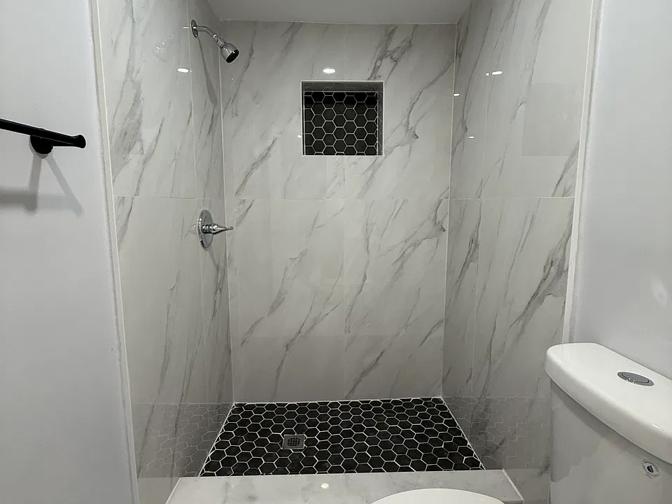 Bathroom with brand new toilet, shower, vanity.