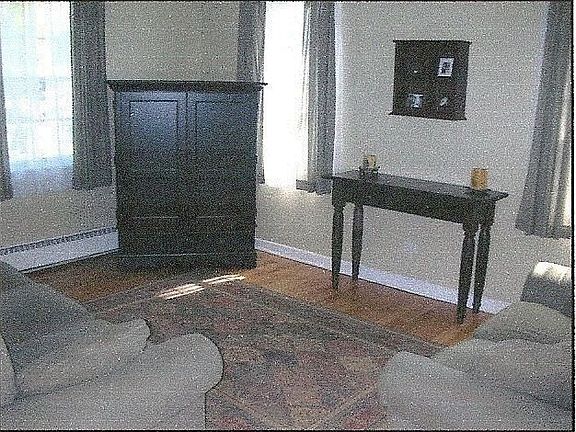 Living room offers oak floors and ample natural light  (3 new windows)