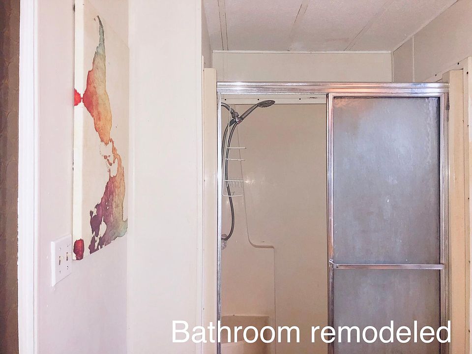 Kitchen newly painted, shower door and walk in shower, painted cabinets with linen closet and laminate flooring