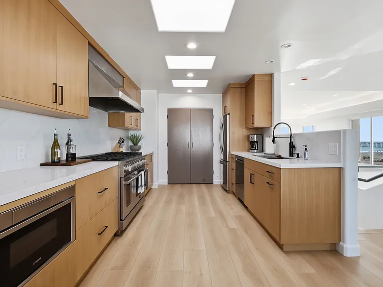 At the top of the third floor you will find a chef's kitchen with walk-in pantry, breakfast nook, 8-sit dining table, and rooftop patio with direct stair access to the street