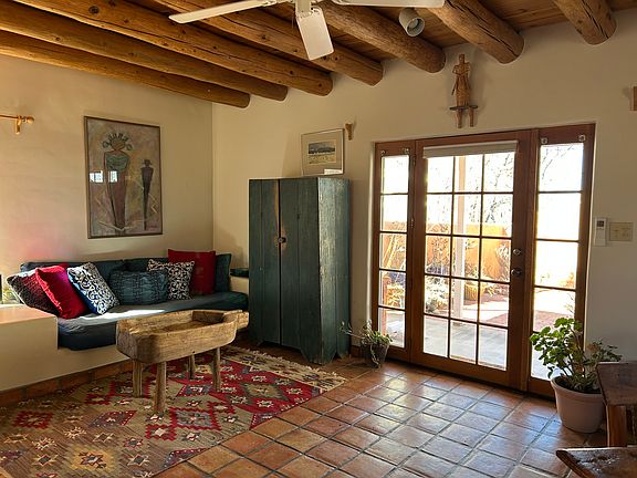 Nambe Casita living room looking out at the walled patio and entry.