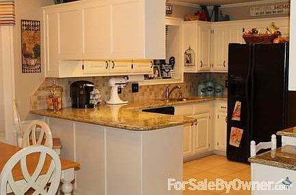 Kitchen has double ovens, porcelain cooktop, beautiful granite and tile.