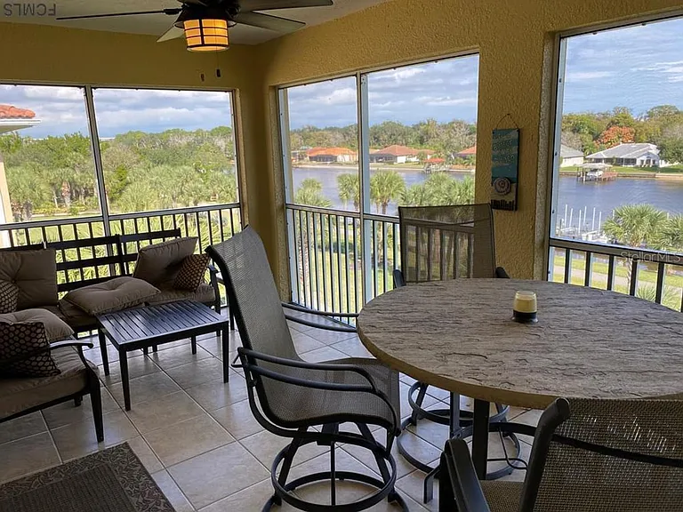 Balcony with high-top table for 4, sectional sofa, and paddle fan to enjoy the beautiful views