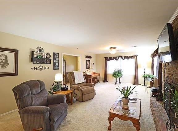 Living Room w/ plush neutral carpet & extra room & light for hobbies, music, office, or entertaining.