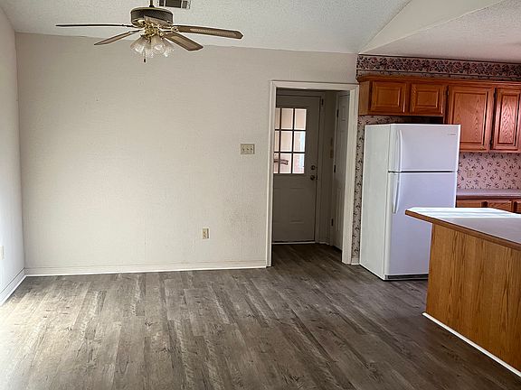 looking from living area into dining room kitchen on the right