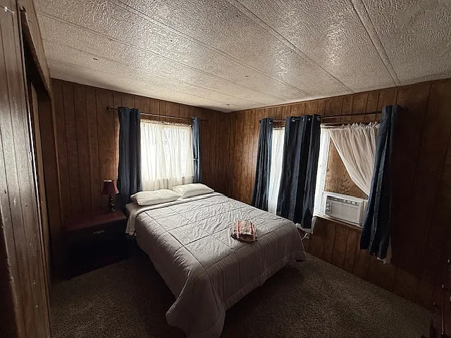 Bedroom 3 with large closet and window air conditioner.