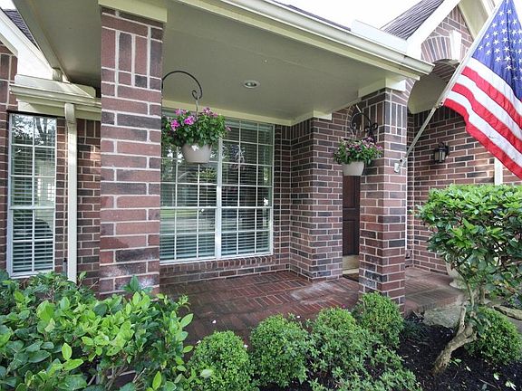 Walk up to this beautiful covered brick porch and come on it!