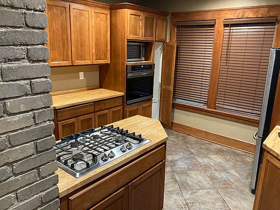 Nice cabinets, built-in stainless oven, stainless refrigerator & 2nd island with gas.