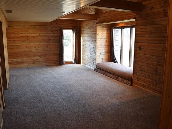 Living Room with lots of wood on walls and ceilings
