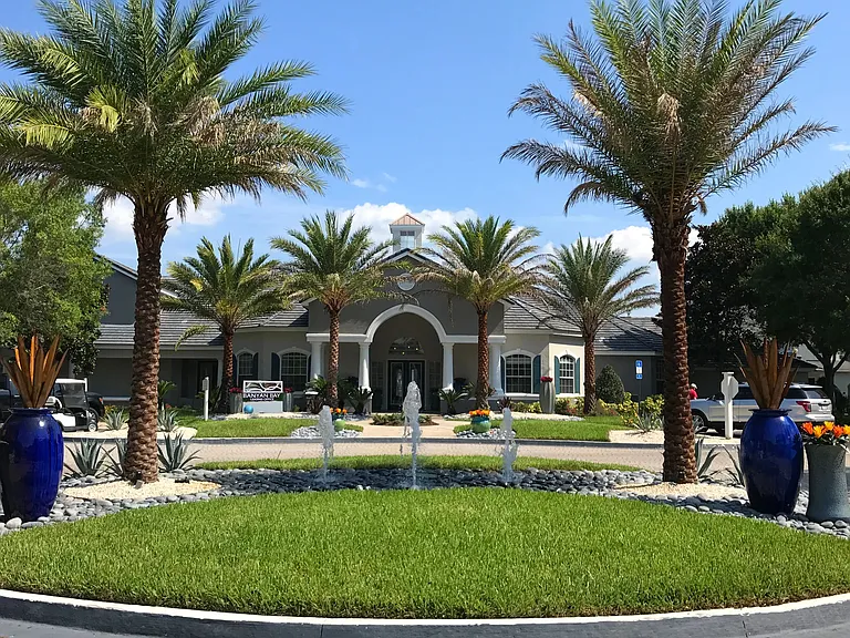 Immerse yourself in a vibrant oasis at the entry of Banyan Bay Apartments Leasing Center, adorned with lush greenery and swaying palm trees. Let us help you discover your perfect apartment home!