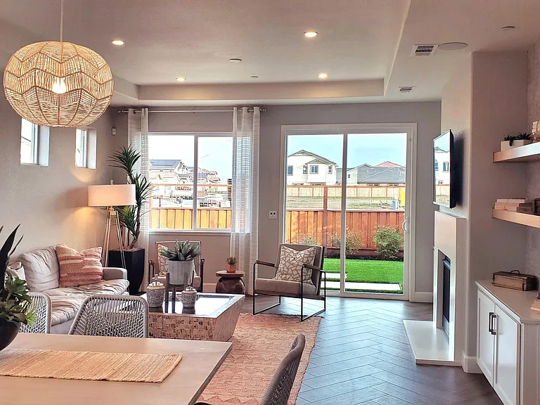 Living room, upgraded floors, and granite countertops, with a cooling fan.