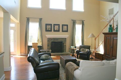 2-story Living Room with Stone FP and rear staircase to Bonus room
