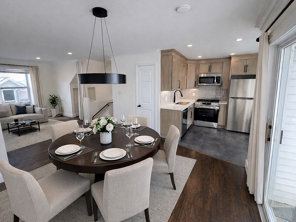 Virtually staged open concept living/dining/kitchen.