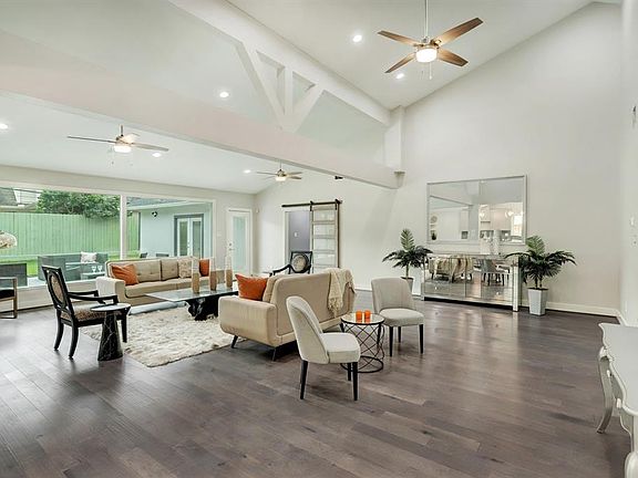 A family room with architectural features, wood floors and tons of square footage