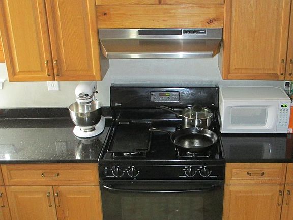 Kitchen with granite and vented hood