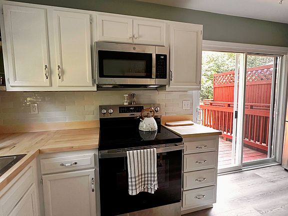 new Butcher block counters, new backsplash, New stove, new microwave, patio doors to deck
