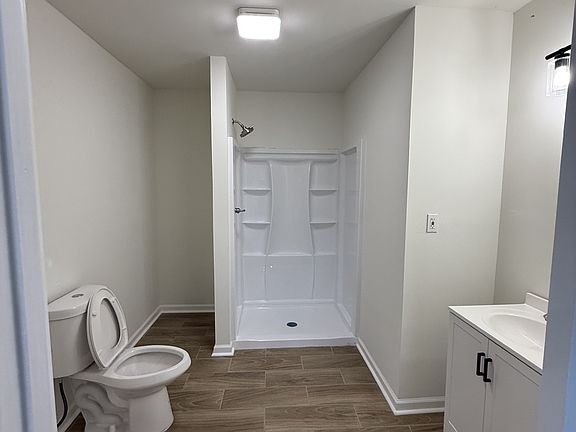 Bathroom- vanity on the right, and stackable washer and dryer hook up on the left.