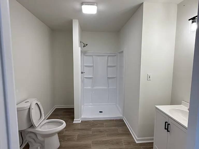 Bathroom- vanity on the right, and stackable washer and dryer hook up on the left.