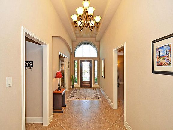 Long open hallways with 12' ceilings in almost every location add depth to this great home.