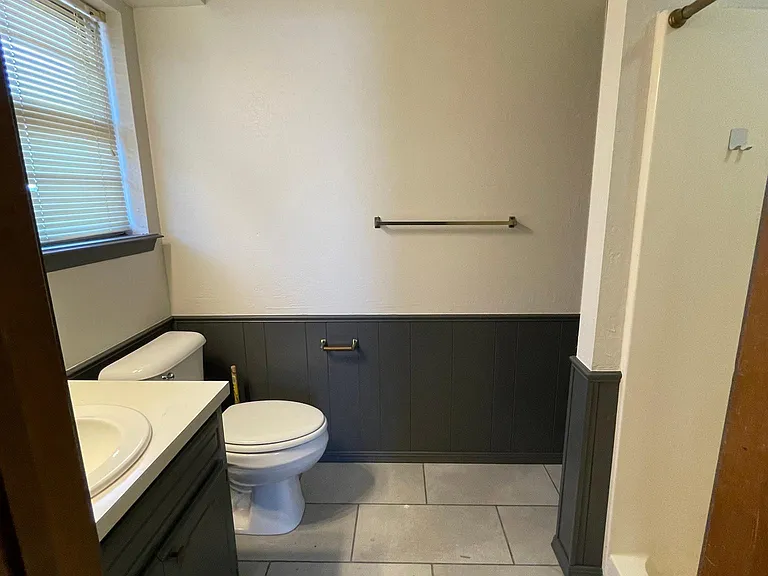 vanity, stool, shower, and small closet behind