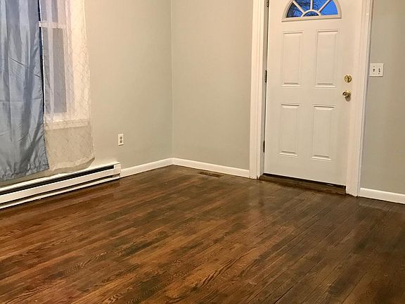 Spacious living room, with beautifully refinished hardwood floors.