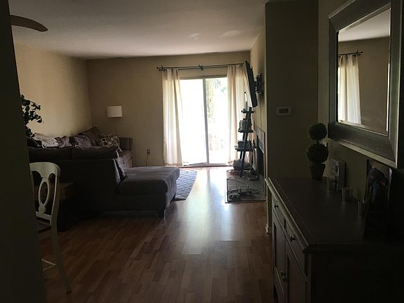 Living room w/ slider to private deck overlooking babbling brook