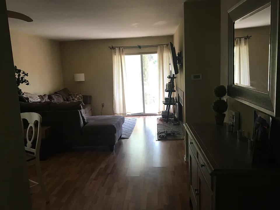 Living room w/ slider to private deck overlooking babbling brook