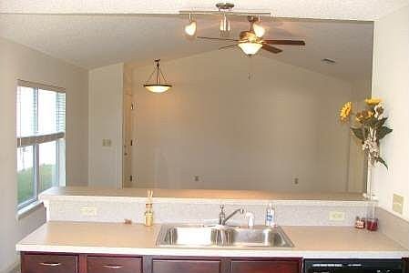 View of Living Room from Kitchen. Ceiling fan is remote controlled. 